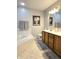 Bathroom featuring a corner tub, wood vanity with drawers, and a neutral color scheme at 2303 Eagle Brook Dr, Shelbyville, IN 46176