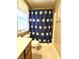 Full bathroom showcasing a bathtub with shower, toilet, and stylish blue floral shower curtain at 2303 Eagle Brook Dr, Shelbyville, IN 46176
