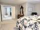 Bedroom view, showcasing doorway access, a floral bedspread, and dresser with mirror at 2303 Eagle Brook Dr, Shelbyville, IN 46176