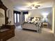 Inviting bedroom with floral bedding, dresser, and ample natural light from large windows at 2303 Eagle Brook Dr, Shelbyville, IN 46176