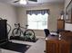 Bedroom featuring a ceiling fan, a desk, and home gym equipment at 2303 Eagle Brook Dr, Shelbyville, IN 46176