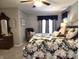 Spacious bedroom featuring a floral bedspread and a comfortable sitting area by the window at 2303 Eagle Brook Dr, Shelbyville, IN 46176