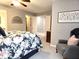 Bedroom featuring a comfortable chair, floral bedding, and a view into the hallway at 2303 Eagle Brook Dr, Shelbyville, IN 46176