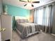 Bright bedroom featuring a ceiling fan, complemented by a large window and stylish curtains at 2303 Eagle Brook Dr, Shelbyville, IN 46176