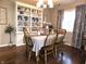 Dining room with built-in shelving, chandelier, and seating for six at 2303 Eagle Brook Dr, Shelbyville, IN 46176