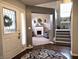 View of front door with hardwood floors, a staircase, and arched entryway into the living room at 2303 Eagle Brook Dr, Shelbyville, IN 46176