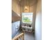 Entryway with carpeted stairs, white accent table, a large window, and light fixture at 2303 Eagle Brook Dr, Shelbyville, IN 46176