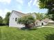 Charming two-story home with green lawn, mature tree, and quaint front porch at 2303 Eagle Brook Dr, Shelbyville, IN 46176