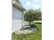White metal bench against light grey siding surrounded by rocks and greenery at 2303 Eagle Brook Dr, Shelbyville, IN 46176