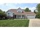 Charming ranch style home with a well manicured lawn, inviting porch, and attached two car garage at 2303 Eagle Brook Dr, Shelbyville, IN 46176