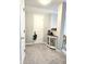 Foyer with decorative table, neutral carpeting, and white door at 2303 Eagle Brook Dr, Shelbyville, IN 46176
