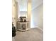 Foyer featuring a decorative table with storage and neutral carpeting at 2303 Eagle Brook Dr, Shelbyville, IN 46176