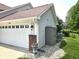 Spacious attached two-car garage with brick accents and a convenient side-yard storage shed at 2303 Eagle Brook Dr, Shelbyville, IN 46176