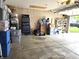 Spacious garage with ample storage, a workbench, and a roll-up door at 2303 Eagle Brook Dr, Shelbyville, IN 46176
