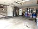 Functional garage with storage solutions, work area, and access door at 2303 Eagle Brook Dr, Shelbyville, IN 46176