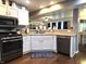 Well-lit kitchen with white cabinets, modern appliances, and open view into living and dining spaces at 2303 Eagle Brook Dr, Shelbyville, IN 46176