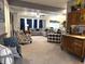 Open floorplan living room with large sectional, patterned chairs, and an antique wooden cabinet at 2303 Eagle Brook Dr, Shelbyville, IN 46176