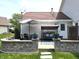 Relaxing backyard patio with an umbrella, seating and landscaping, perfect for outdoor entertaining at 2303 Eagle Brook Dr, Shelbyville, IN 46176
