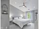Serene bedroom featuring vaulted ceilings, a ceiling fan, and a large window for natural light at 248 Legends Creek Pl # 207, Indianapolis, IN 46229