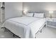 Bedroom featuring a neatly made bed, neutral colors, and ample lighting, creating a cozy space at 248 Legends Creek Pl # 207, Indianapolis, IN 46229