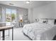 Bright bedroom featuring large window, stylish drapes, work desk, and neutral color scheme for relaxation at 248 Legends Creek Pl # 207, Indianapolis, IN 46229