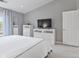 Bright bedroom with a large window, white furniture, and modern decor for a clean, minimalist feel at 248 Legends Creek Pl # 207, Indianapolis, IN 46229