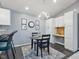 Dining room with modern lighting and view into the kitchen and office nook at 248 Legends Creek Pl # 207, Indianapolis, IN 46229