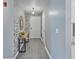 Condo hallway with decorative mirror, console table, and stylish flooring at 248 Legends Creek Pl # 207, Indianapolis, IN 46229