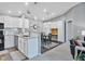 An open concept kitchen featuring white cabinets, granite counters, and stainless steel appliances at 248 Legends Creek Pl # 207, Indianapolis, IN 46229