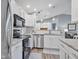 Bright kitchen with stainless steel appliances, granite countertops, and white cabinets at 248 Legends Creek Pl # 207, Indianapolis, IN 46229