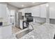 Updated kitchen with stainless appliances, bright countertops, and adjacent laundry at 248 Legends Creek Pl # 207, Indianapolis, IN 46229