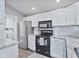 Modern kitchen with stainless appliances, white cabinetry, and granite countertops at 248 Legends Creek Pl # 207, Indianapolis, IN 46229