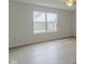 Sunlit bedroom with durable hard surface floors and a large window overlooking the yard at 2485 Bristol Dr, Franklin, IN 46131