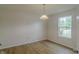 Bright bedroom with laminate flooring, a large window, neutral colored walls and baseboards at 2485 Bristol Dr, Franklin, IN 46131
