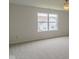 Bright bedroom with large window offering neighborhood views and neutral carpeting at 2485 Bristol Dr, Franklin, IN 46131