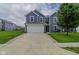 Charming two-story home featuring blue siding, a white garage door, and a well-manicured front lawn at 2485 Bristol Dr, Franklin, IN 46131