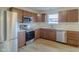 Well-lit kitchen with stainless steel appliances and wood cabinetry offering style and functionality at 2485 Bristol Dr, Franklin, IN 46131