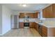 Modern kitchen with stainless appliances, wood cabinets, and hard surface floors at 2485 Bristol Dr, Franklin, IN 46131
