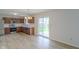 Open kitchen area with stainless appliances, wood cabinets, and a sliding glass door to the backyard at 2485 Bristol Dr, Franklin, IN 46131