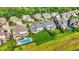 Aerial shot of a neighborhood showcasing large homes, green lawns, and a swimming pool at 2789 W High Grove Cir, Zionsville, IN 46077