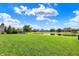Green lawn extending to a serene pond providing a beautiful landscape at 2789 W High Grove Cir, Zionsville, IN 46077
