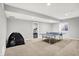 Basement area with a ping pong table, carpeted floor, and a separate room with exercise equipment at 2789 W High Grove Cir, Zionsville, IN 46077