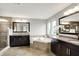 A luxurious bathroom featuring a soaking tub, dual vanities with granite countertops, and a walk-in shower at 2789 W High Grove Cir, Zionsville, IN 46077