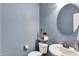 Stylish powder room featuring elegant fixtures, a round mirror, and fresh neutral wall paint at 2789 W High Grove Cir, Zionsville, IN 46077