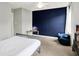 Well-lit bedroom featuring modern gray accents, a striking navy wall, and a comfortable beanbag chair at 2789 W High Grove Cir, Zionsville, IN 46077