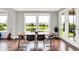 Dining room featuring modern decor, hardwood floors, and a view of the pond at 2789 W High Grove Cir, Zionsville, IN 46077