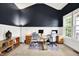 Home office showcasing a custom desk setup with ample space and great natural light from two large windows at 2789 W High Grove Cir, Zionsville, IN 46077