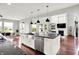 Modern kitchen with a stainless steel farmhouse sink, granite countertops, and open views to the living space at 2789 W High Grove Cir, Zionsville, IN 46077