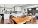 Modern kitchen with granite countertops, stainless steel appliances, and a rustic wood table at 2789 W High Grove Cir, Zionsville, IN 46077
