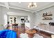 Open-concept living space with stylish furnishings, dining area, and a view into the kitchen with sleek finishes at 2789 W High Grove Cir, Zionsville, IN 46077
